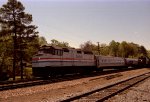 AMTK 268 leads a northbound passenger train past a freight train